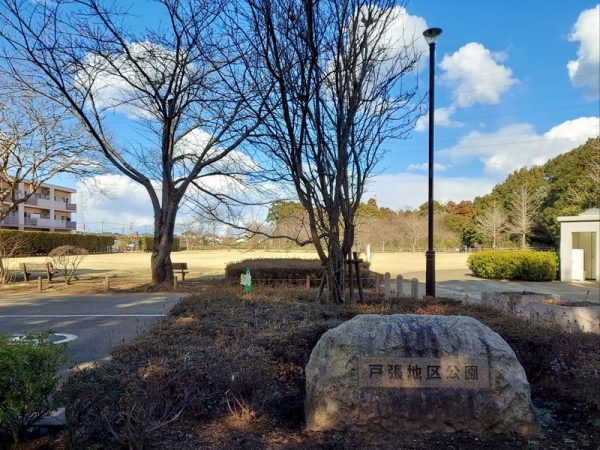 戸張地区公園は2か所に分かれていますが、日体高校から来る場合、左側に見えてくる公園の中に「へそ」があります。「へそ」の角柱はこの写真からもわずかに見えていますよ！