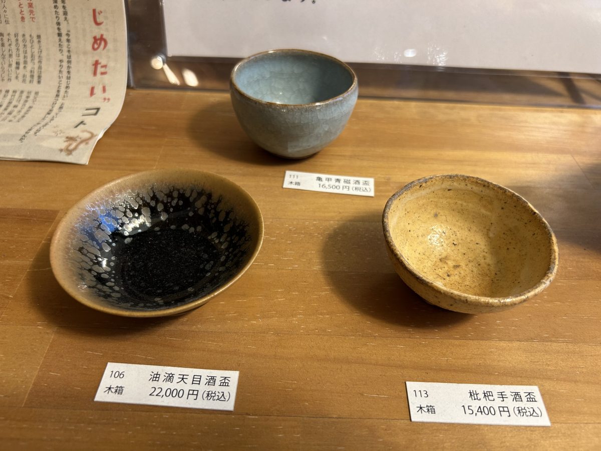 天坊 昌彦氏による富田焼の酒盃。もっとお求めやすい価格のお皿やマグカップなども。奥様の天坊 庸子さんも陶芸家でその作品も販売