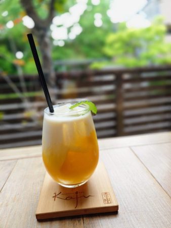 カレーに合うマンゴーラッシーと外の緑の風景